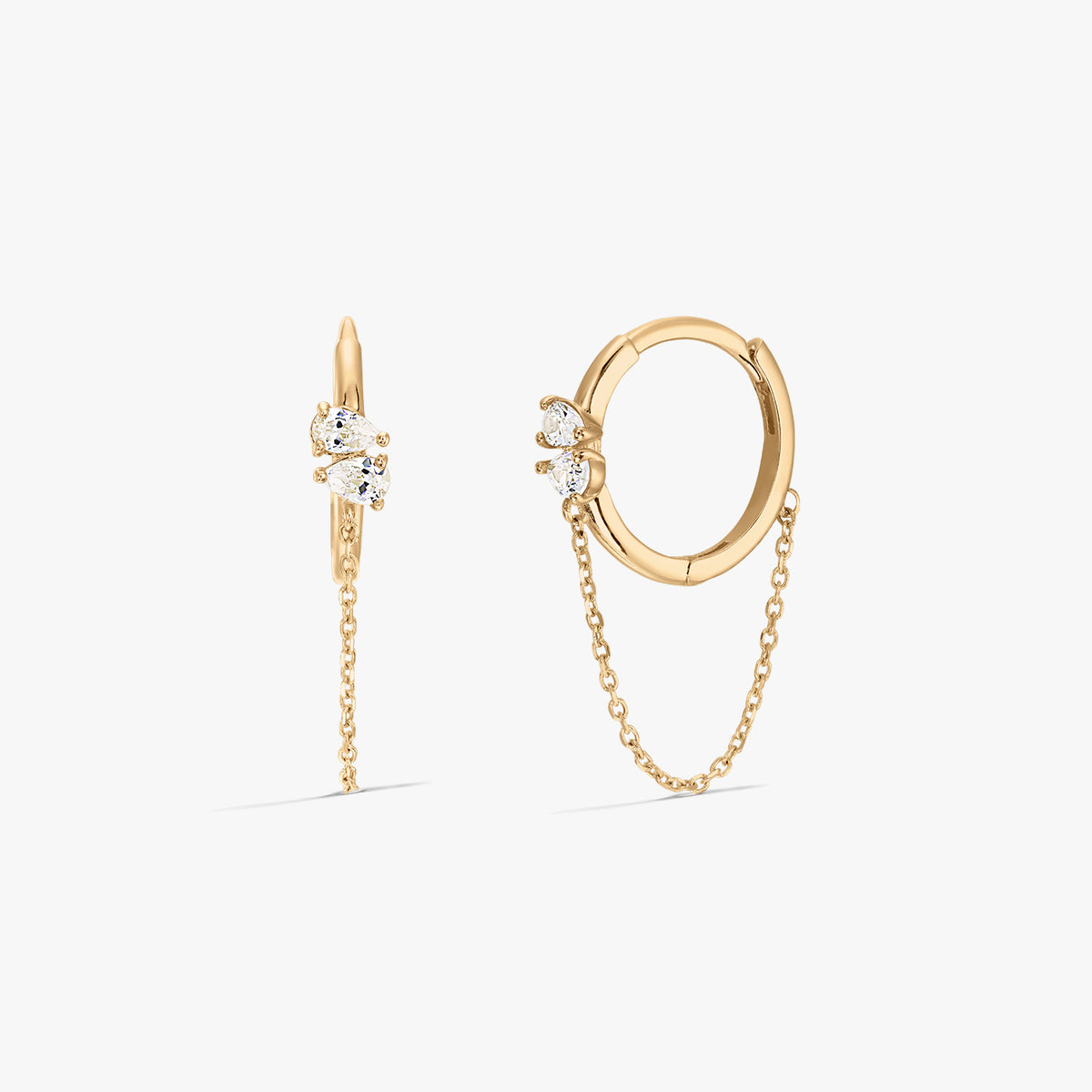 Elegant gold hoop earrings with zirconia stones and a chain detail on a white background.
