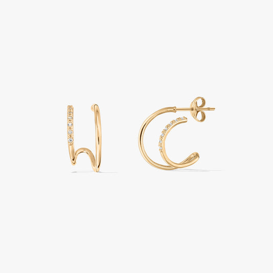 Pair of gold double hoop earrings with embedded stones on a white background.