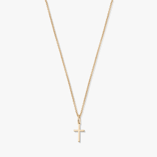 Minimalist 14K yellow gold necklace with a small cross pendant on a fine chain, isolated on a white background.