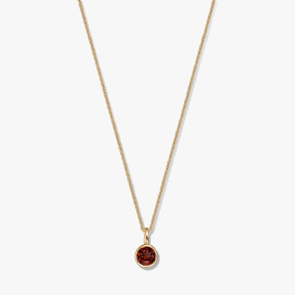 Gold‑plated sterling silver birthstone necklace with a round bezel‑set garnet pendant on a delicate chain, isolated on a white background.