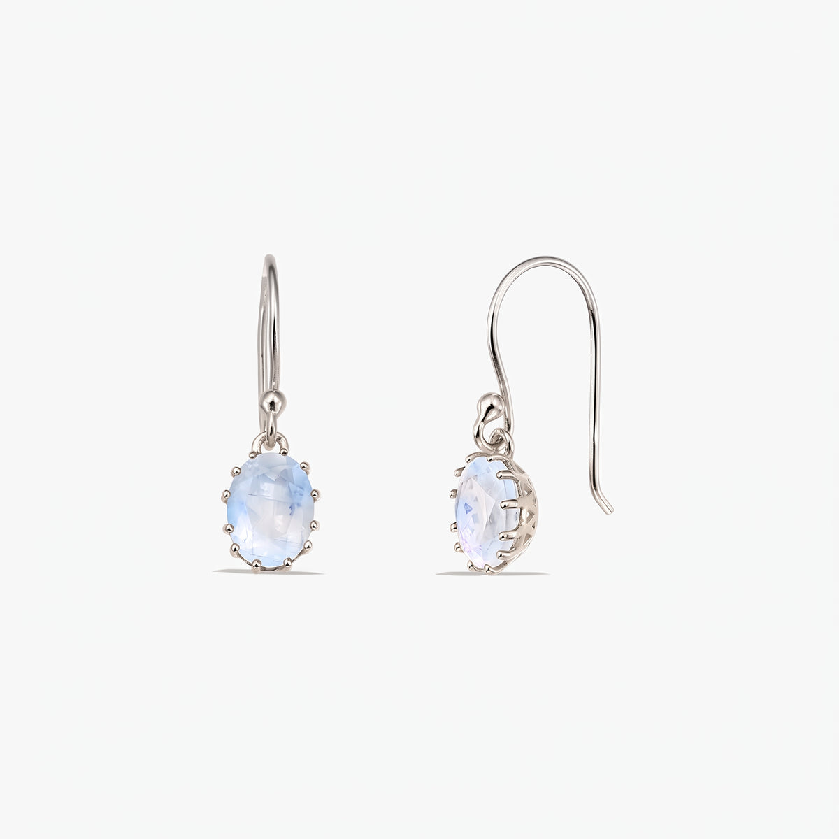 Pair of sterling silver drop earrings with oval faceted moonstone stones on French hooks, shown on a white background (front and side views).