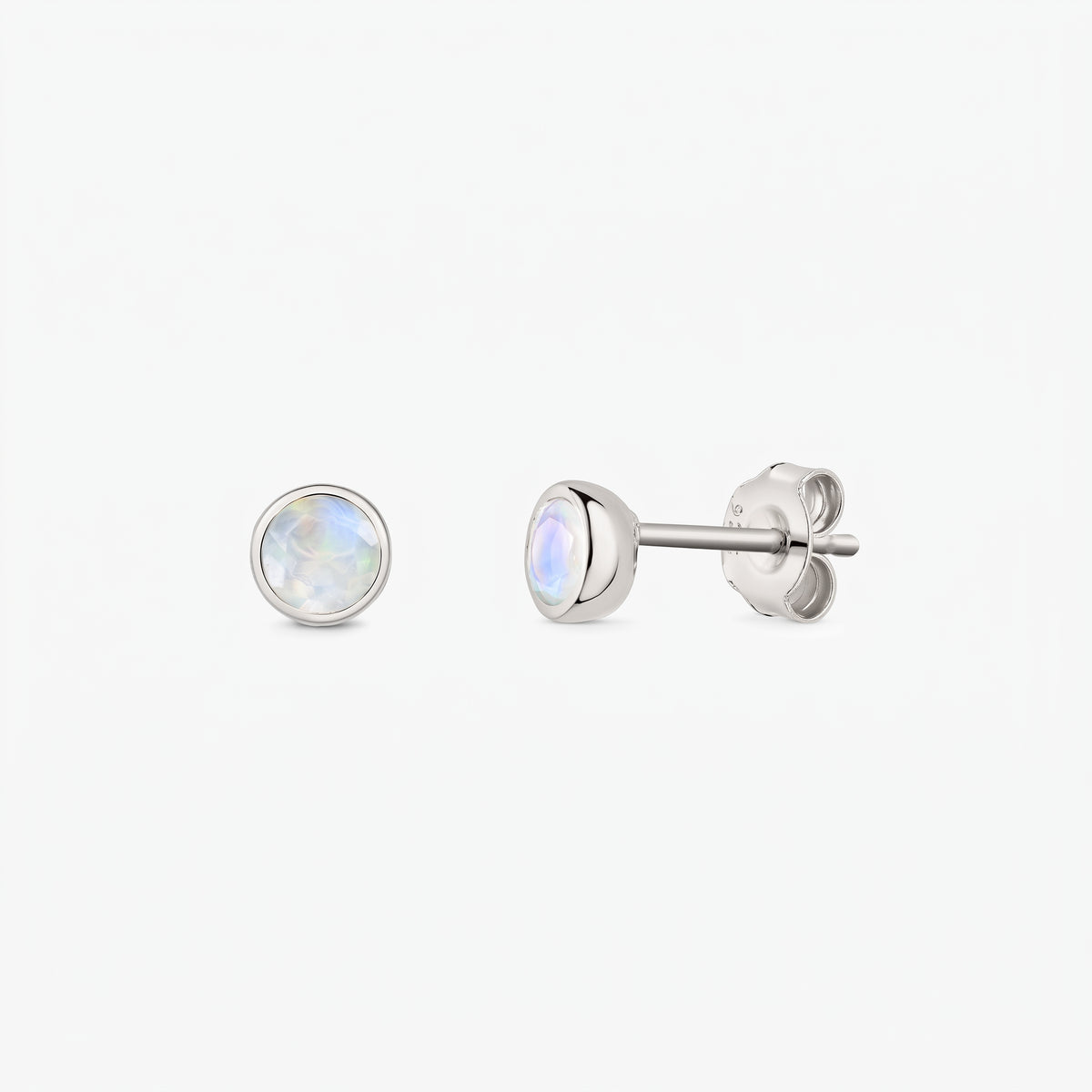 Pair of 925 sterling silver moonstone stud earrings on a white background, shown front and side with butterfly backs and bezel-set round iridescent stones.