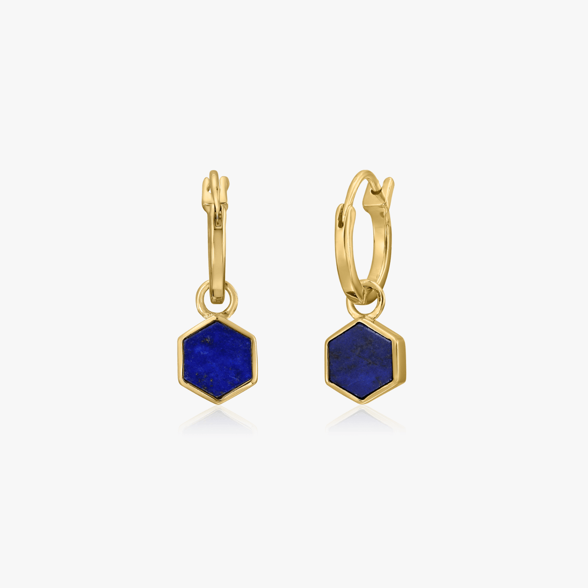 Pair of gold-plated silver earrings with hexagon-shaped blue lapis lazuli stones on a white background.